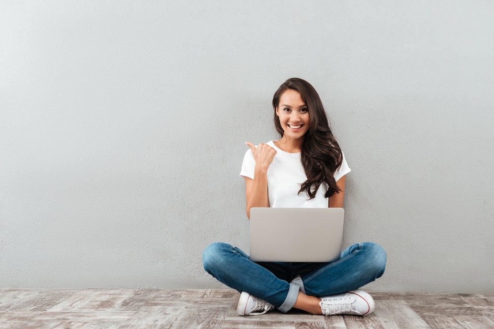 Happy smiling woman studying on laptop